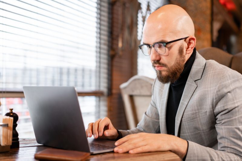 Bald Man on Laptop