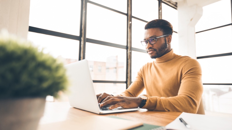 Black Man Working Yellow Turtleneck Sweater Laptop