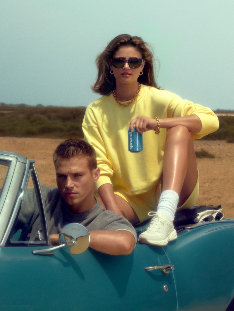 Getting behind the wheels of a vintage car, Matthew Noszka poses with Taylor Hill for CCC Sprandi's fall 2021 campaign.