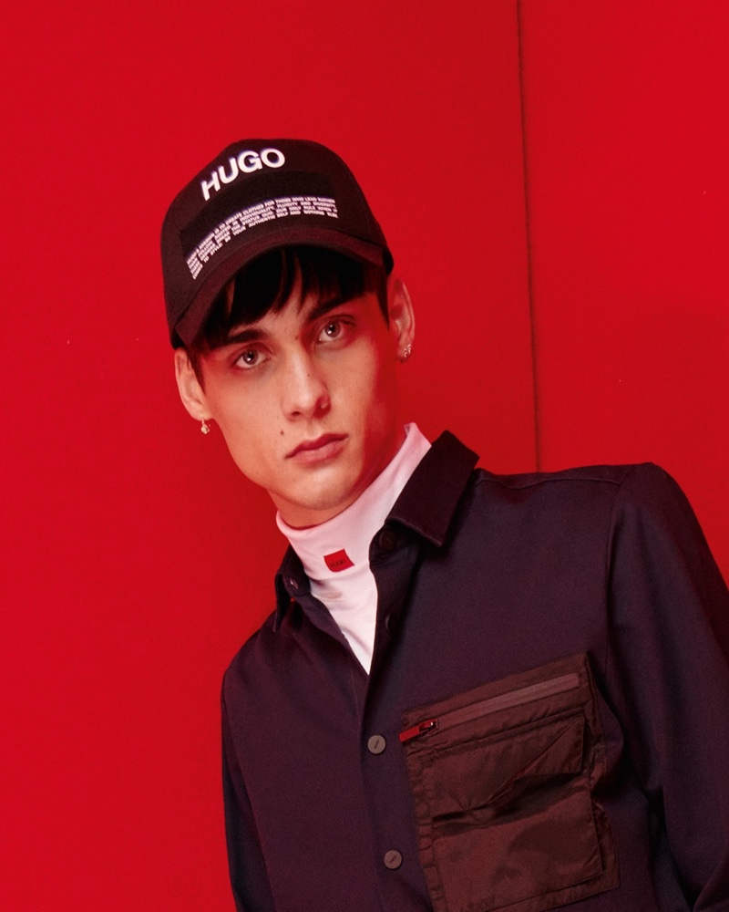 Ludwig Wilsdorff sports a HUGO Manifesto logo cap with more branded fashions from the label's fall-winter 2021 collection.