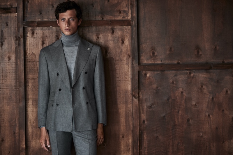 The face of Luigi Bianchi Mantova for fall, Alexis Maçon-Dauxerre makes a case for gray in a sleek double-breasted suit and knit turtleneck.