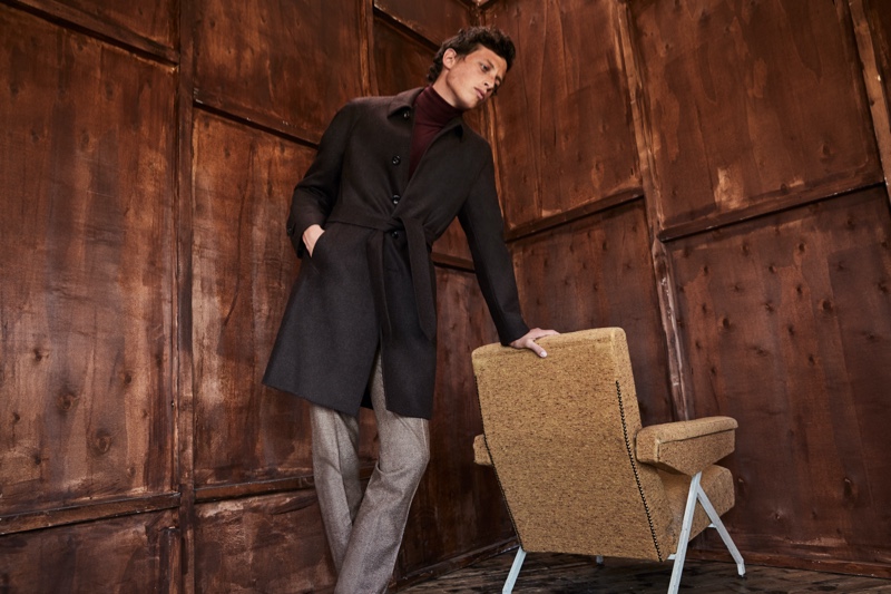 A chic vision, Alexis Maçon-Dauxerre dons a belted coat by Luigi Bianchi Mantova.