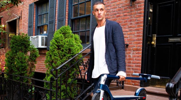 Electric Scooters Are Becoming a Fashion Statement Among Young Urban Men Man Carrying Unagi Electric Scooter