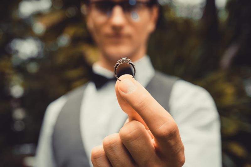 Man Holding Diamond Engagement Ring