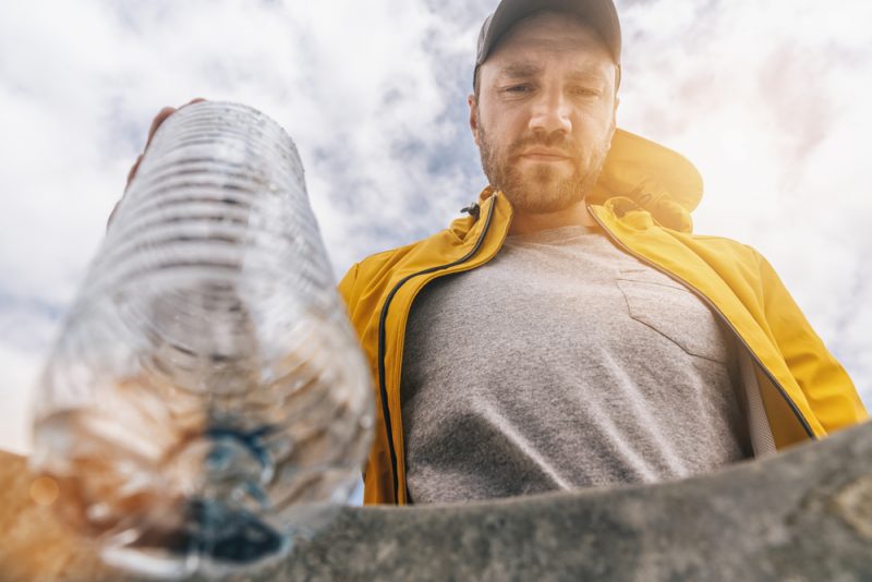 Man Recycling Plastic Bottle