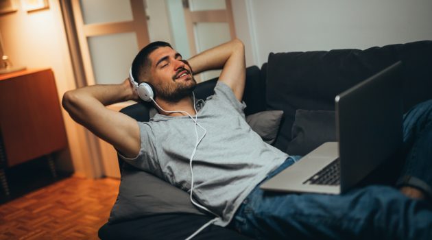 Man Relaxing at Home Listening to Music