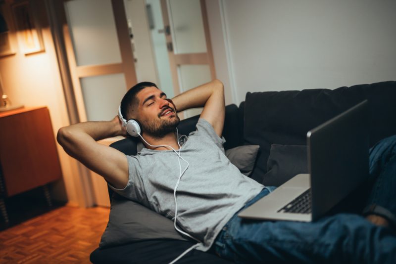 Man Relaxing at Home Listening to Music