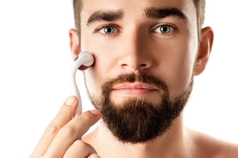 Man Using Dermaroller Face Beard