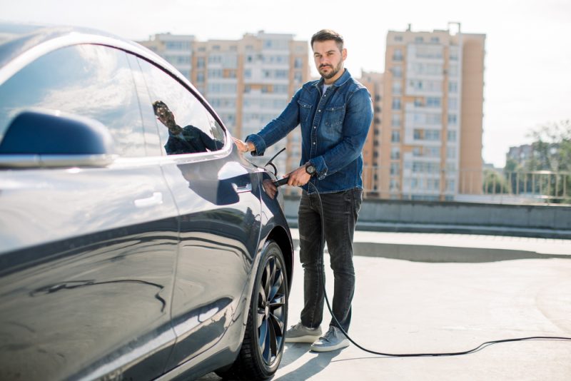 Man in Denim Electric Car