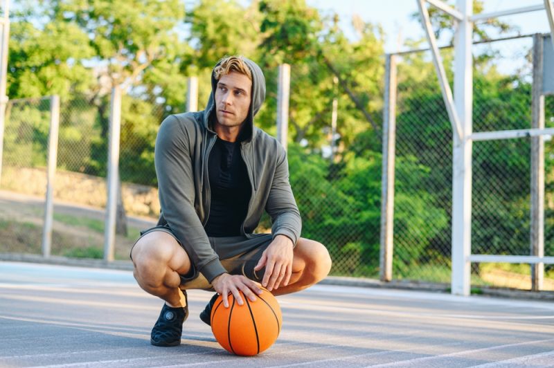 Man on Basketball Court with Sneakers