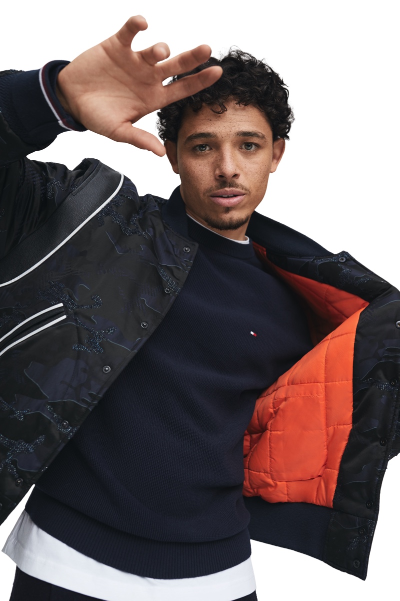 Sporting a bomber jacket, Anthony Ramos stars in Tommy Hilfiger's Pass the Mic campaign.