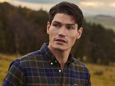 Venturing outdoors, Sam Way sports a tartan shirt from Barbour.