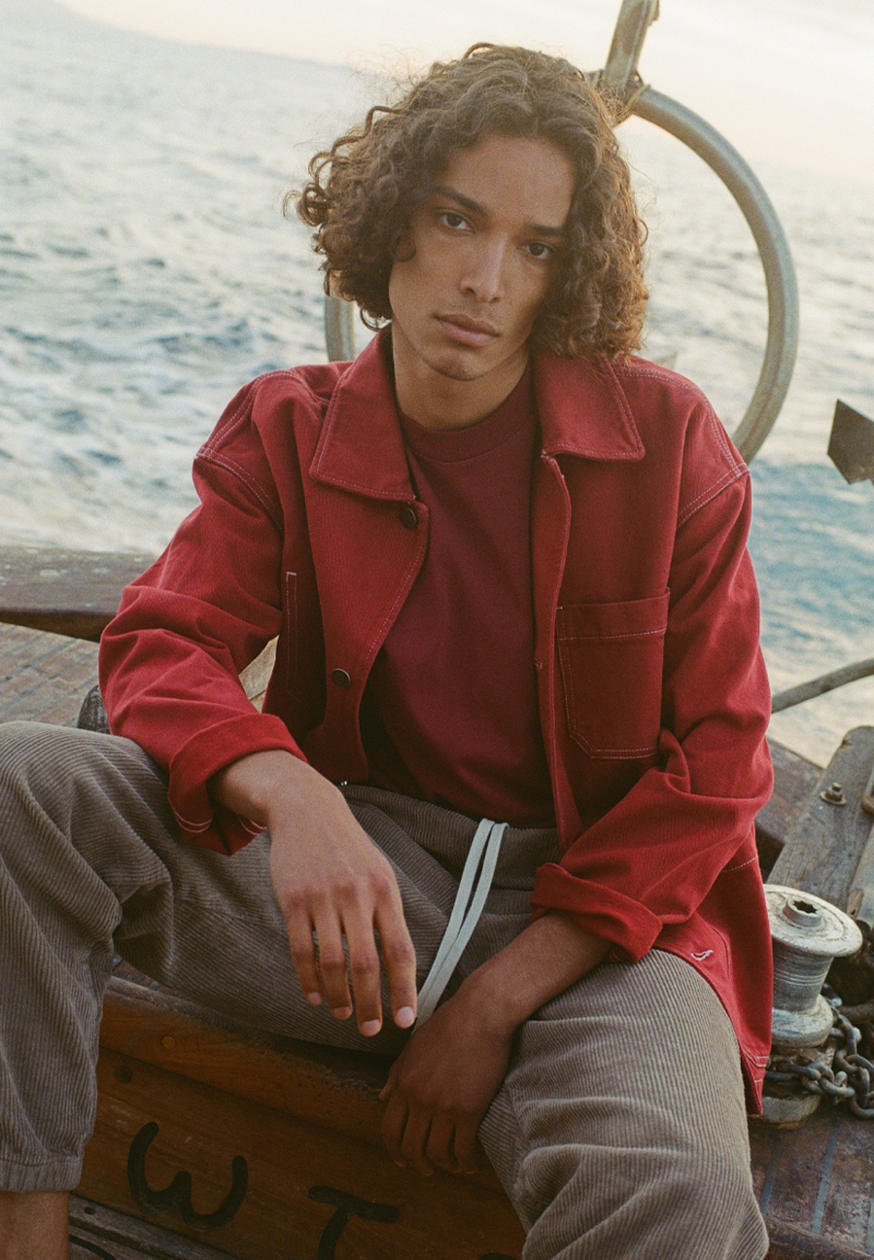 Djairo Mulder wears a red shirt jacket over a tee with corduroy pants from American Vintage.