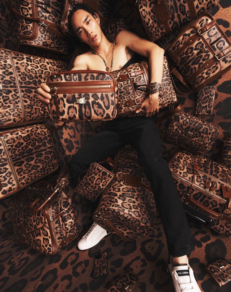 Marcelo Zhang poses with leopard print bags from Dolce & Gabbana's Crespo Leo collection.
