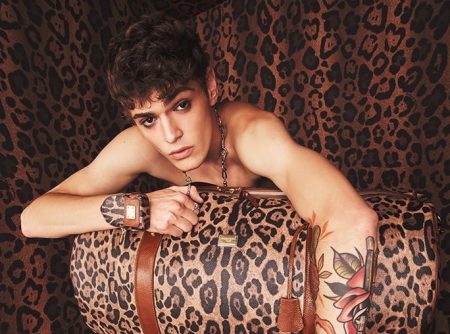 Mattia Giovannoni poses with a leopard print travel bag from Dolce & Gabbana's Crespo Leo collection.