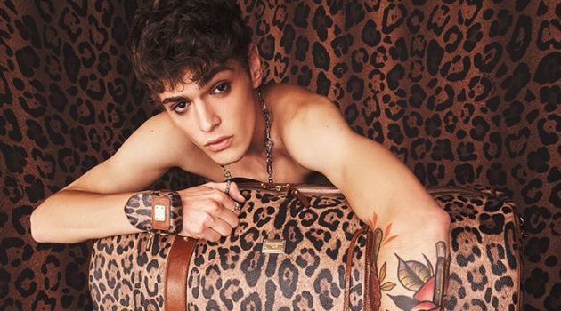 Dolce & Gabbana Revisits Leopard with Crespo Leo Collection Mattia Giovannoni poses with a leopard print travel bag from Dolce & Gabbana's Crespo Leo collection.