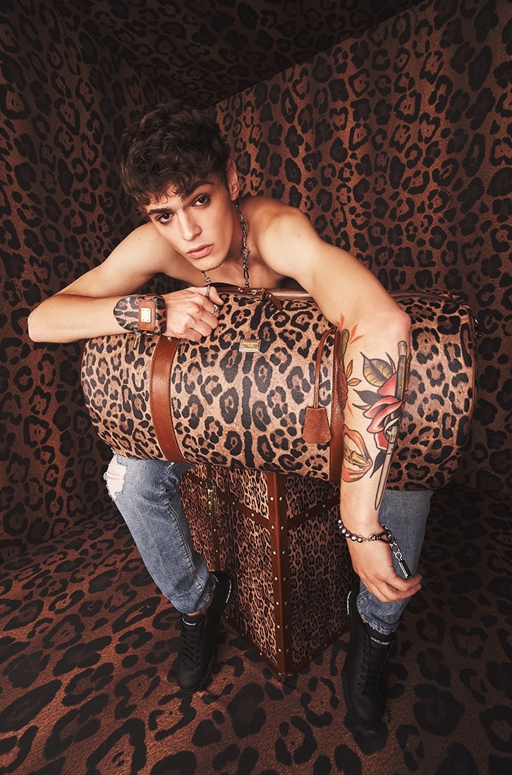 Mattia Giovannoni poses with a leopard print travel bag from Dolce & Gabbana's Crespo Leo collection.