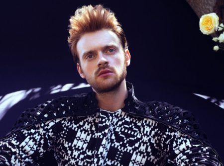 Embracing a graphic black and white look, Finneas wears Comme des Garçons with a Valentino cape for VMAN.