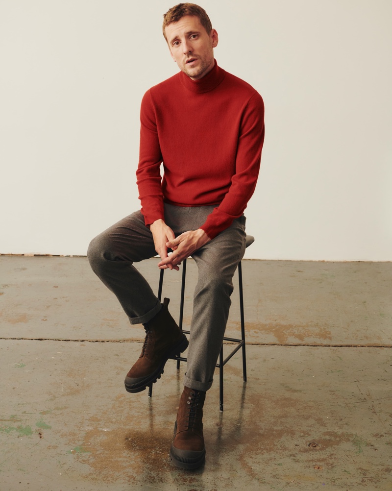 In front and center, George Barnett models a turtleneck sweater with trousers and brown suede boots from Massimo Dutti.