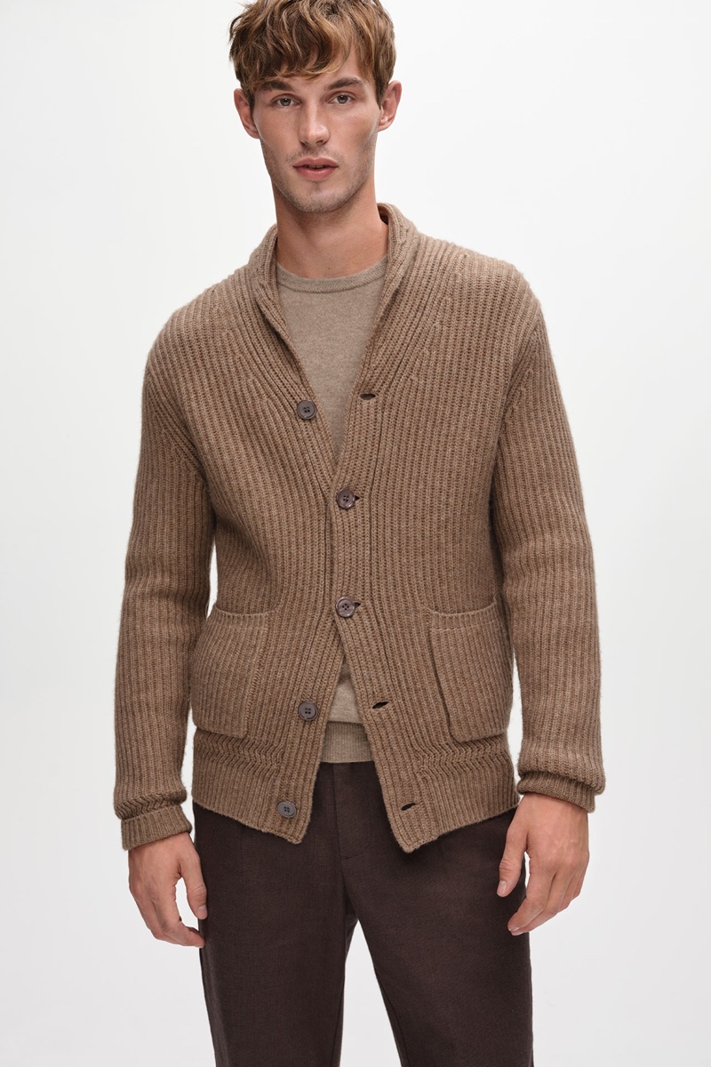 In front and center, Kit Butler models a camel-colored knit cardigan from Jaeger's fall-winter 2021 collection.