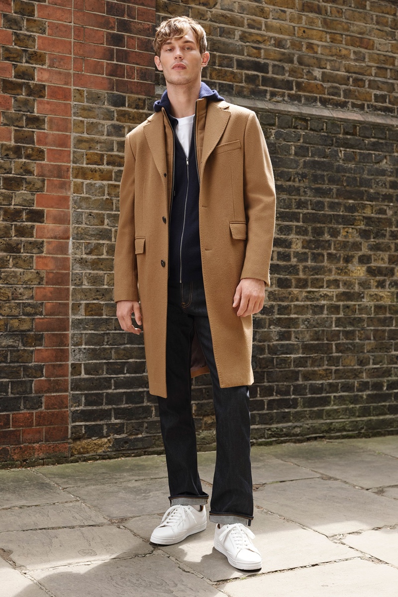 Stepping outside, Kit Butler wears a versatile camel coat by Jaeger.