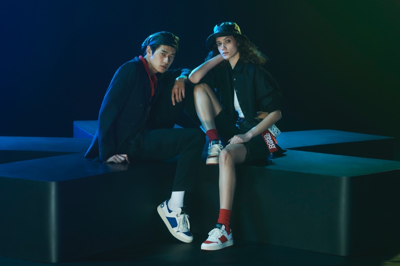 Models Yudai Tateishi and Liz Panova sport sneakers from the Jimmy Choo x Eric Haze collection.