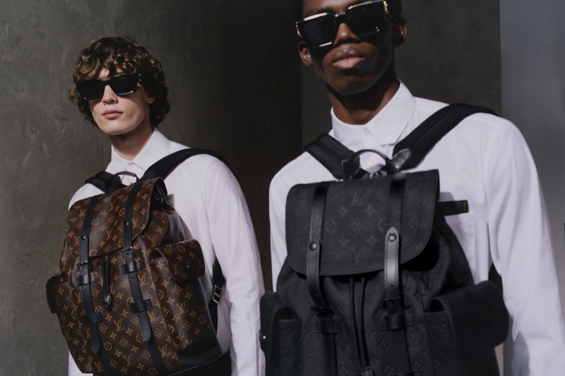 Models Freek Iven and Ottawa Kwami wear Louis Vuitton's Christopher PM backpacks. 