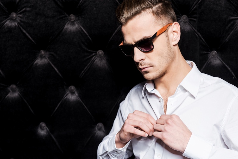 Man Buttoning Up Shirt Sunglasses Man Buttoning Up Shirt Sunglasses
