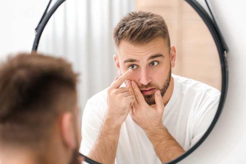 Man Using Eye Contacts Mirror