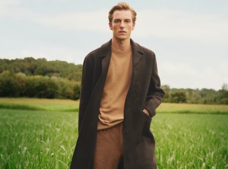 Quentin Demeester dons a single-breasted coat with a crewneck sweater and corduroy pants by Mango.