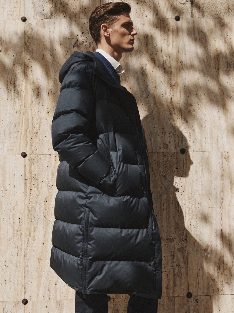 Xavier Gibson dons a a hooded puffer from Massimo Dutti's fall-winter 2021 collection.