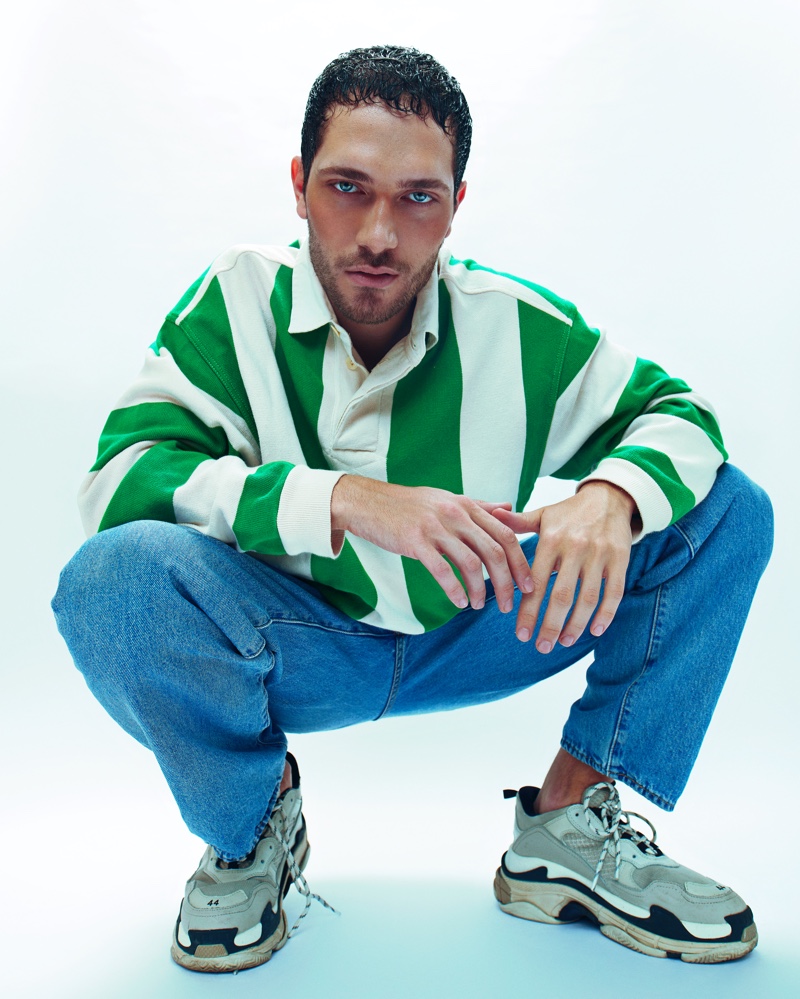 Pedro wears rugby shirt YMC, jeans Levi's, and sneakers Balenciaga.