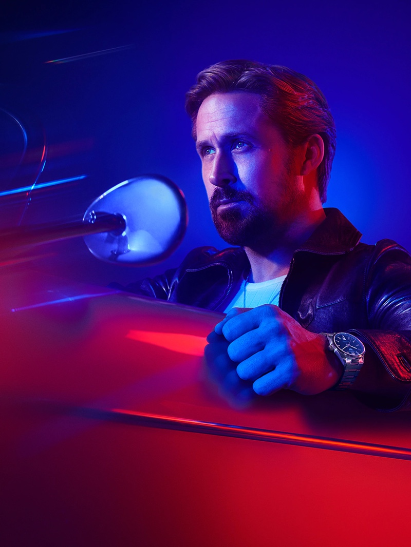 Getting behind the wheels of a vintage car, Ryan Gosling wears TAG Heuer's Carrera watch in a new campaign image.