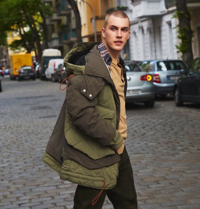 On the move, Felix Mayr models a quilted color-block jacket by Scotch & Soda.