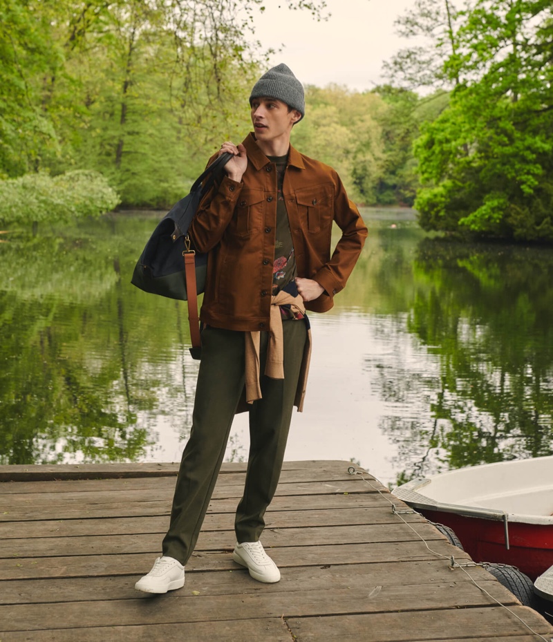 Layering for fall, Adrien Sahores dons a Scotch & Soda twill trucker jacket with a graphic top and chinos.