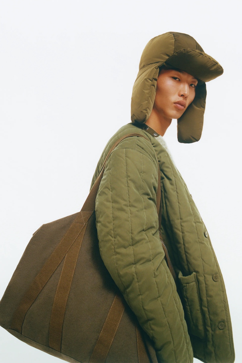 In front and center, James Baek rocks a vertical quilt jacket with a soft fabric bag from Zara.