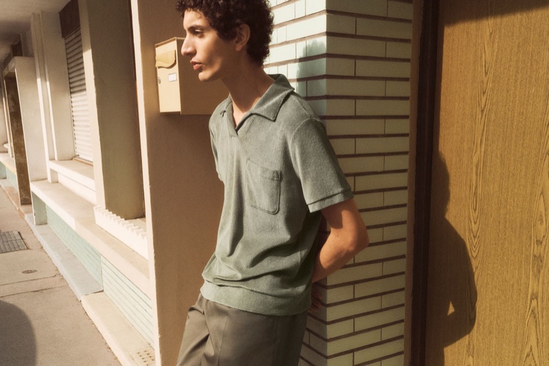 A chic vision, Tak Bengana models a terry polo from A.P.C.'s spring-summer 2022 collection.