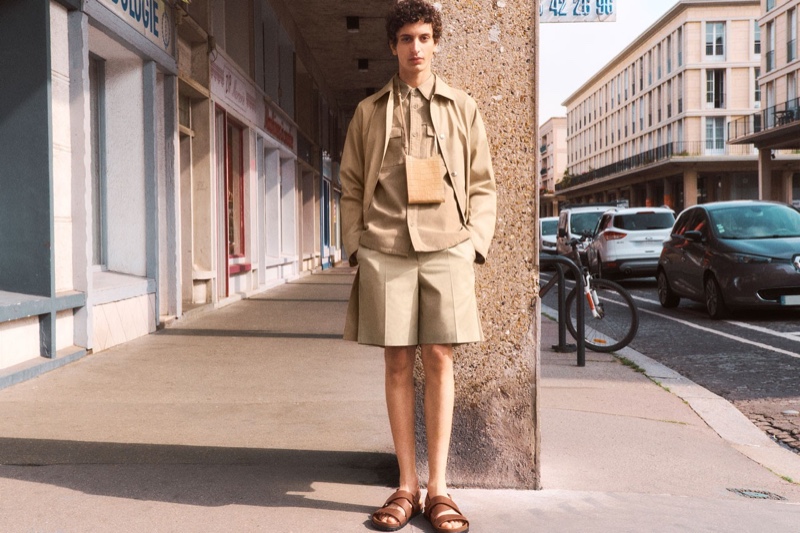 Embracing monochrome style, Tak Bengana dons a lightweight shirt, jacket, and pleated shorts from A.P.C.'s spring-summer 2022 collection.