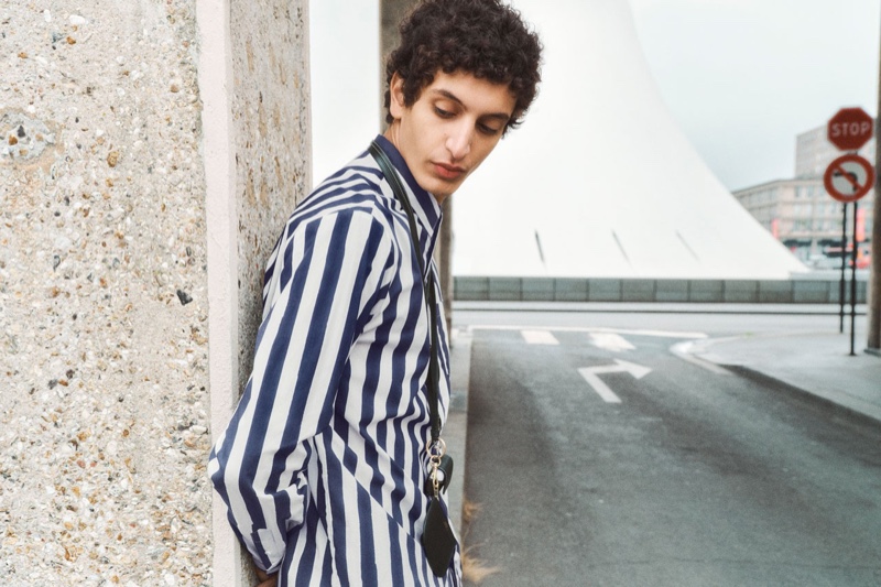 Sported a striped shirt, Tak Bengana showcases fashions from A.P.C.'s spring-summer 2022 collection.