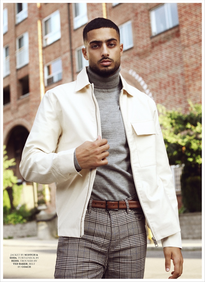 Ali wears jacket Scotch & Soda, turtleneck Reiss, trousers Ted Baker, and belt Coach.