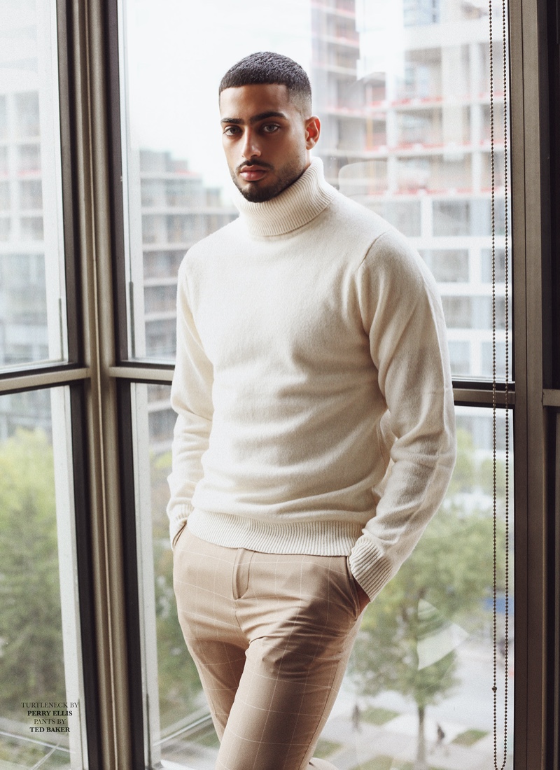 Ali wears turtleneck sweater Perry Ellis and pants Ted Baker.