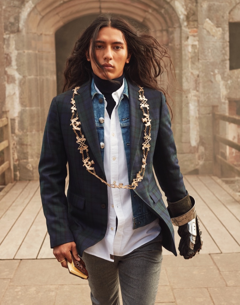 Donning a tartan blazer over a denim jean jacket, white button-down shirt, and turtleneck, Cherokee Jack stars in Banana Republic's holiday 2021 campaign.