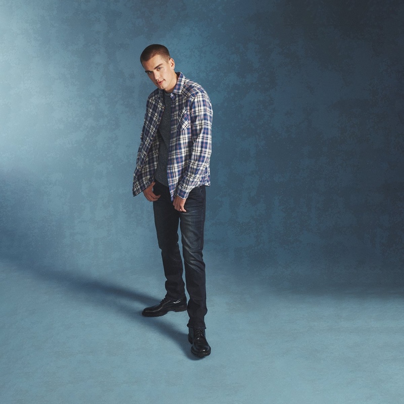 In front and center, Jake Hart wears a plaid shirt with distressed denim jeans from Buffalo David Bitton.