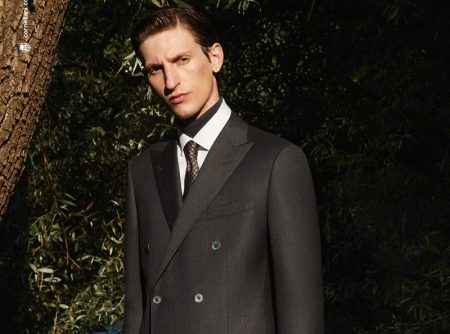 Theodor Pal dons an elegant double-breasted suit for Corneliani's fall-winter 2021 campaign.