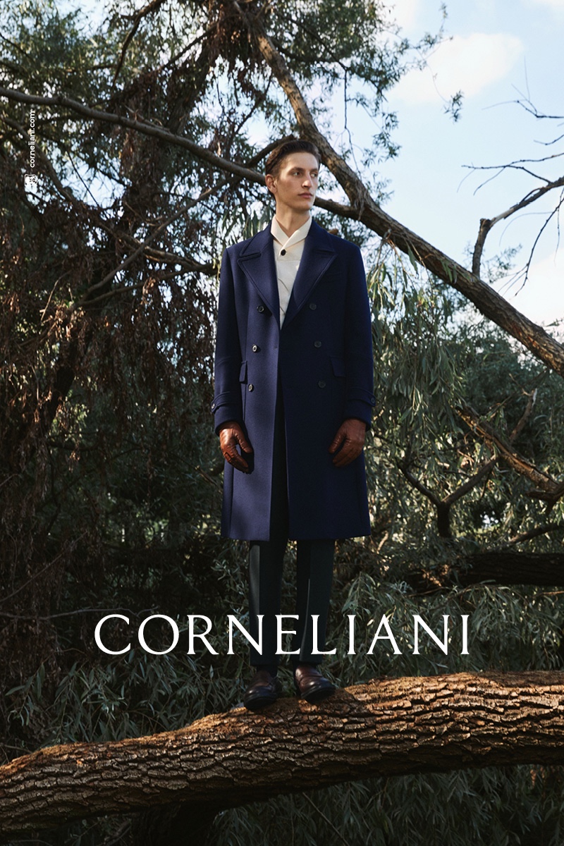 In front and center, Theodor Pal wears a navy double-breasted coat for Corneliani's fall-winter 2021 campaign.
