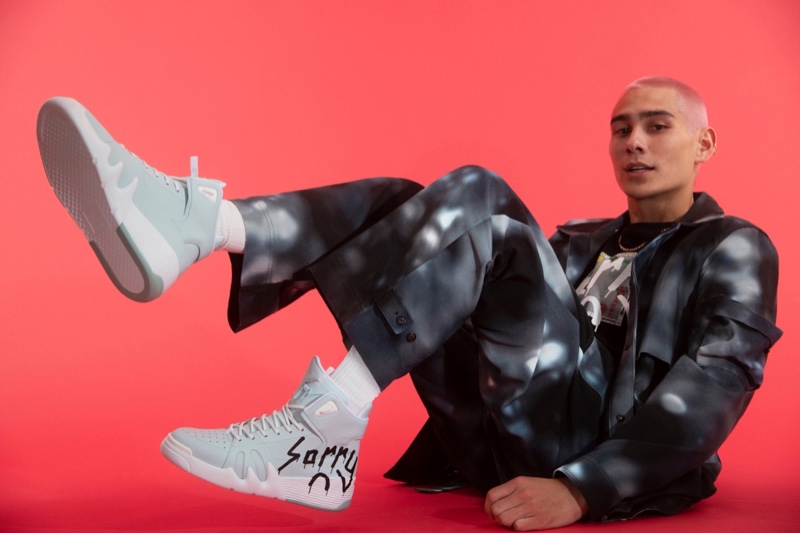 Posing in fresh sneakers, Evan Mock showcases his Sorry in Advance x Giuseppe Zanotti collaboration.