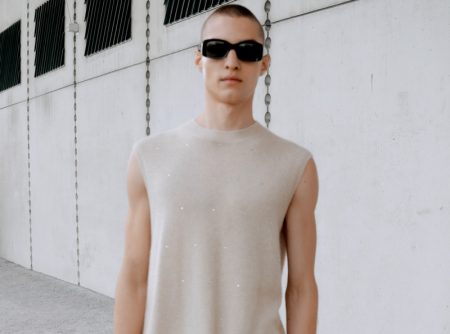 Dressed in a cashmere sweater vest and cotton trousers, David Shyn showcases pieces from Filippa K's spring-summer 2022 collection.
