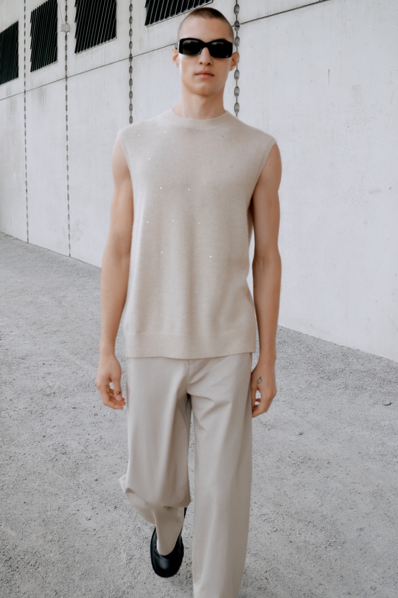 Dressed in a cashmere sweater vest and cotton trousers, David Shyn showcases pieces from Filippa K's spring-summer 2022 collection.