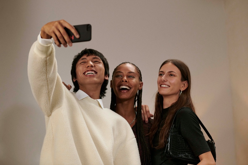 All smiles, Yuuki Tang, Ronja Berg, and Chai Maximus appear in HUGO's holiday 2021 campaign.