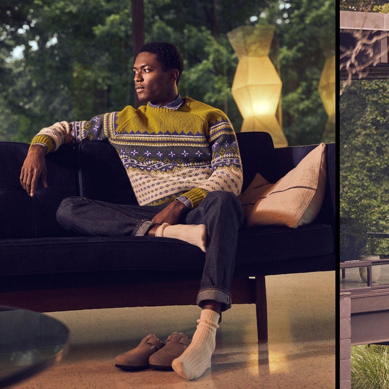 Getting comfortable, Hamid Onifade dons a Todd Snyder fair isle lambswool sweater with slim-fit stretch jeans in indigo rinse, and RoToTo socks.